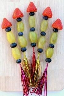 rocketship made of grapes, strawberries, and blueberries