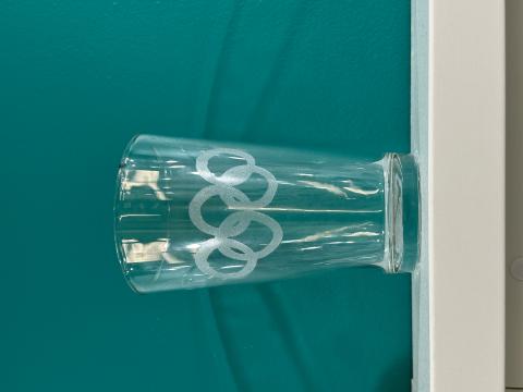 Olympics logo etched onto a glass cup