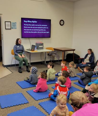 Librarian leading storytime with a group of children