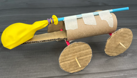 card made out of cardboard and other materials with yellow balloon attached.