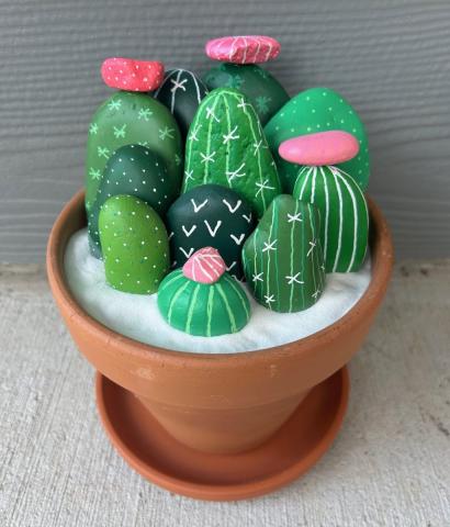 Rocks painted to look like cacti in terra-cotta planter