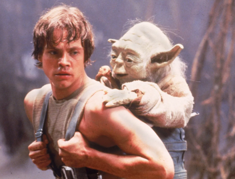 Luke giving Yoda piggyback ride.