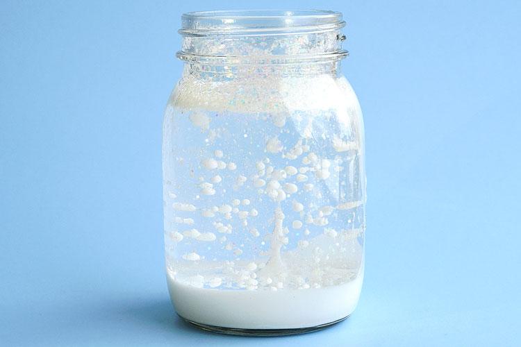 Floating snow in a jar with a blue background.