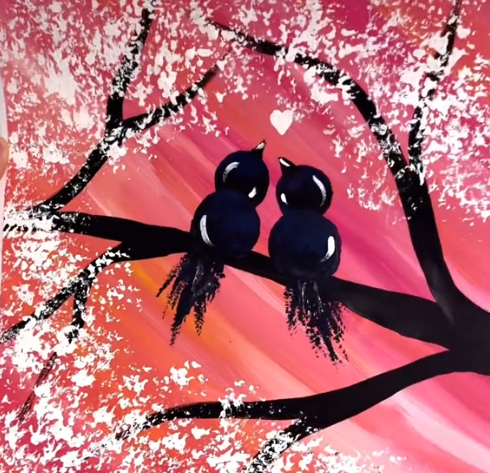 black birds sitting on a branch with a pink background