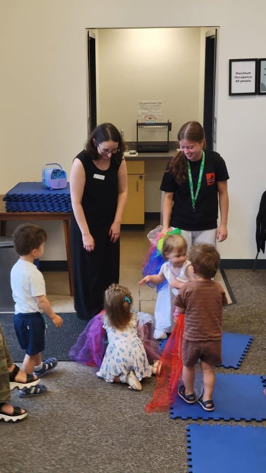 two people leading storytime for children 